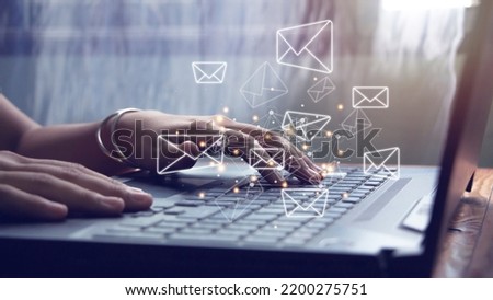 Woman hands using computer laptop and sending online messages with email icon, email marketing concept and newsletter.