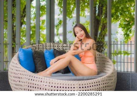 Portrait beautiful young asian woman relax smile leisure around outdoor swimming pool in hotel resort