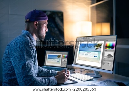 Graphic Designer Working Late At Night In Office