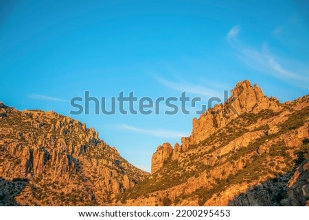 Scenic Santa Catalina Mountain range in Mount Lemmon Arizona against blue sky. A scenic vista of rocky mountains and cliffs with clear sky background on a beautiful day. Royalty-Free Stock Photo #2200295453