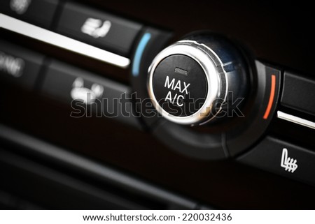 Color detail with the air conditioning button inside a car.