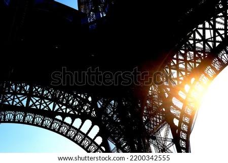 Gigantic Curve of Eiffel Tower with Natural Light Beam Background.