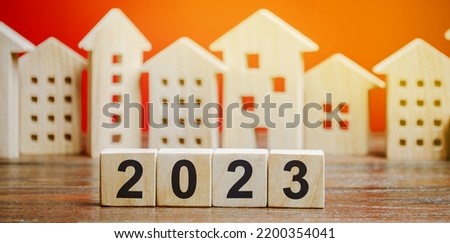 Wooden blocks 2022 and houses. Family budget planning for next year. Investments, plans, savings. Mortgage rates. Real estate concept. Refinance home. Royalty-Free Stock Photo #2200354041