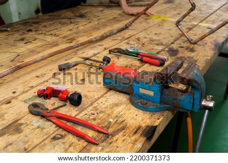 Plumber and tin soldering tools on a workbench