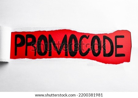 Word Promocode written on red background, view through hole in white paper