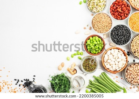 Beans, legumes and green sprouts. Dried, raw and fresh, top view. Red beans, lentils, chickpeas, soybeans. Healthy, nutritious, diet food, vegan protein, micronutrients and fiber sources Royalty-Free Stock Photo #2200385005