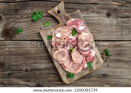 Stomachs chicken in pan. Raw uncooked chicken gizzards, stomach. Culinary, cooking, concept. banner, menu recipe place for text, top view.