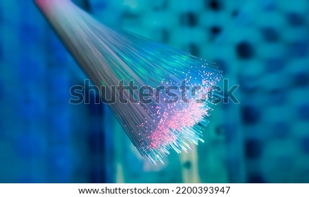 optical fibres on technology background Royalty-Free Stock Photo #2200393947