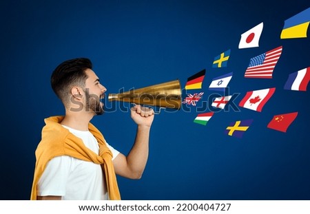 Portrait of interpreter with megaphone and flags of different countries on blue background
