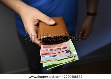 an open purse with euro bank notes