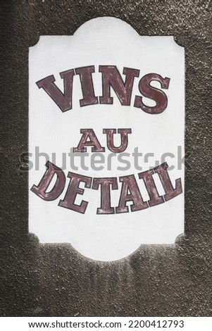 Old facade of a dealer with retail wines called vins au detail in French language