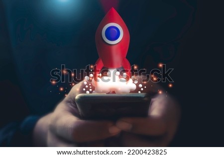 Business man and red rocket flying in space.A man use mobile phone showing hologram stock. fast growing business,save money,investment,bank,finance,Photo financial saving and Startup Concept.