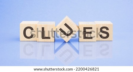 clues word written on wood block for your design, concept Royalty-Free Stock Photo #2200426821
