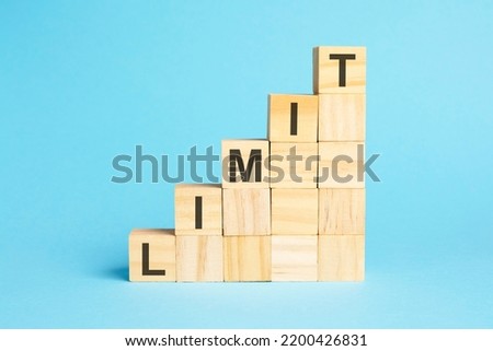 the word limit is written on a wooden cubes. blocks on a bright blue background. corporate hierarchy concept and multilevel marketing Royalty-Free Stock Photo #2200426831
