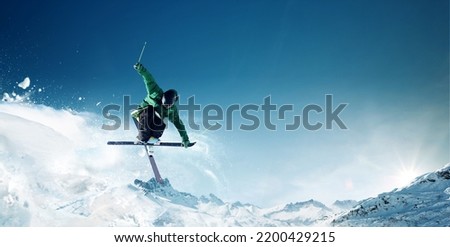 Jumping skier skiing in high mountains	 Royalty-Free Stock Photo #2200429215
