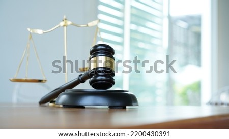 Lawyer or judge's hammer in the court. Auction's hammer is on woo table. Law subject. Judgement subject to judge people. Royalty-Free Stock Photo #2200430391