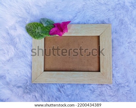 Wooden photo frame with pink flowers and green leaves