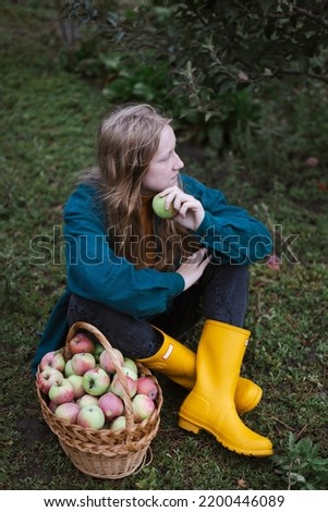 girl and basket  with juicy apples in the garden. aesthetics of rural life
