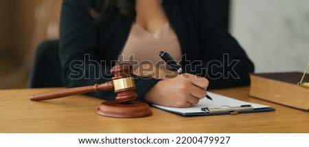 Lawyer business women working and writting in notebook on desk at office. consultant lawyer, justice and law ,attorney, court judge, concept.