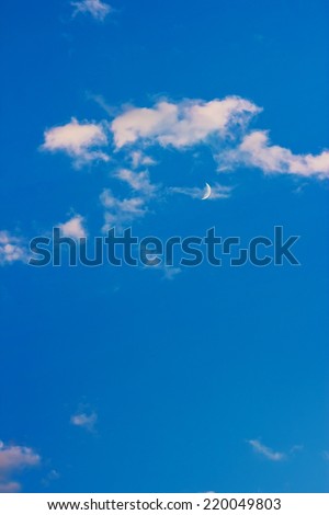 blue evening sky with moon and clouds