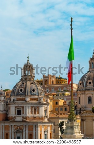 Twin churches in Rome with Italian flag, Italien flag in the center of the Italian capital, Domes of two Catholic churches at the Piazza Venezia in downtown Rome