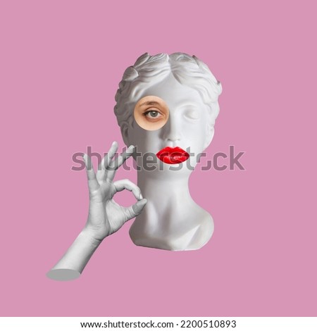 Antique female statue's head with red lips shows the ok gesture with hand isolated on a pink color background. 3d trendy abstact collage in magazine surreal style. 3d contemporary art. Modern design