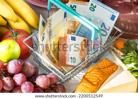 Shopping basket with Euro, food from the store around, Concept of rising food prices in the European Union countries and rising inflation in eurozone Royalty-Free Stock Photo #2200512549