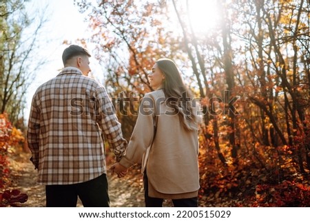 Stylish couple walking and enjoying autumn weather. People, lifestyle, relaxation and vacations concept. Autumn Fashion, style concept. Royalty-Free Stock Photo #2200515029