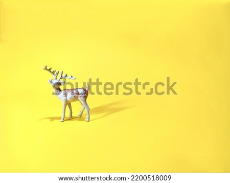 Old toy deer from childhood on a yellow background