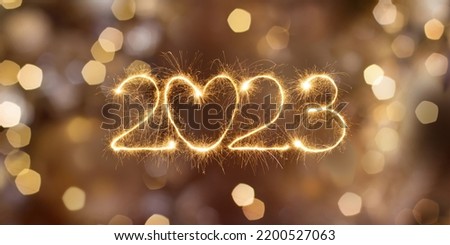 Happy New Year 2023. Beautiful holiday billboard with Sparkling creative text 2023 with heart on festive glowing golden background Royalty-Free Stock Photo #2200527063