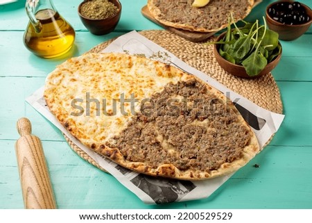 Half Laham Beajin Half Cheese Mashrooha or Lahembajin served in a dish isolated on wooden table side view of middle eastern food