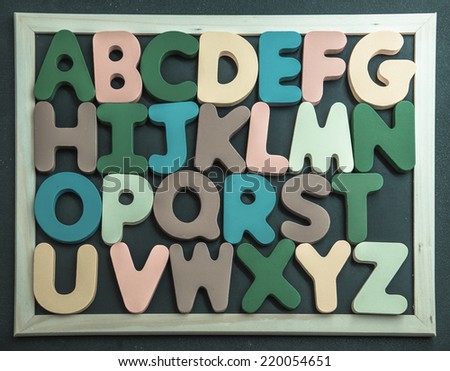 Colorful wooden alphabet on black board3