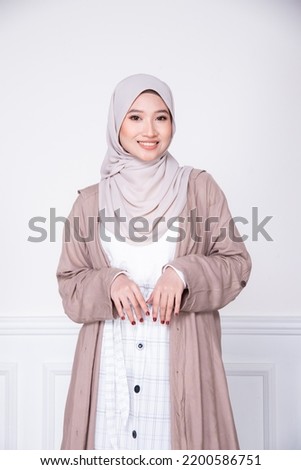 Smiling beautiful asian woman in  hijab with  copy space over isolated background. Royalty-Free Stock Photo #2200586751