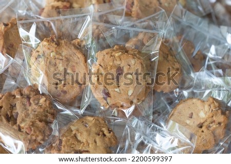 Homemade cookie in plastic bag package with close up shot,food packaging concept. Royalty-Free Stock Photo #2200599397