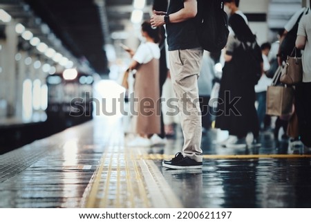 people waiting for the train to arrive Royalty-Free Stock Photo #2200621197