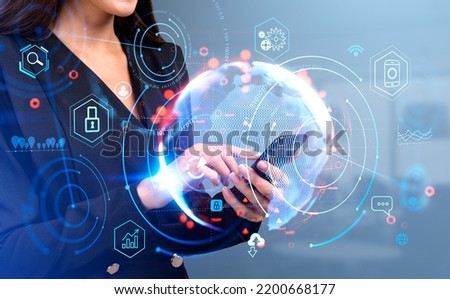 Businesswoman finger touching phone in hand. Earth globe hologram with glowing digital icons hud. Concept of big data and global connection