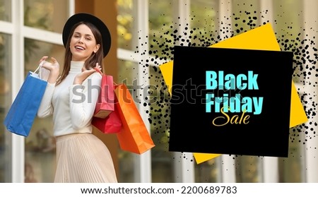 Beautiful young woman with shopping bags outdoors. Black Friday sale