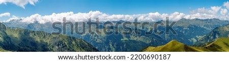 Panoramic view from the Kreuzeck peak (2204 m) to the Hohe Tauern mountain in summer, Central Eastern Alps, Austria. Royalty-Free Stock Photo #2200690187