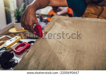 Craftsman working on frame for picture at home