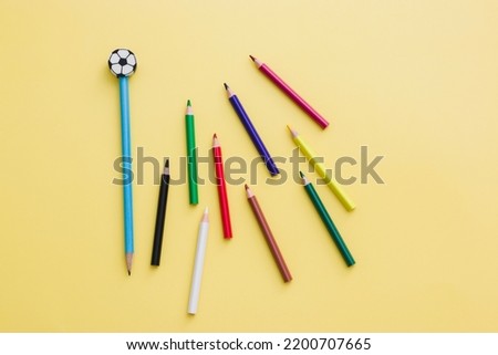 Blue pencil isolated on white background with an eraser in the form of a soccer ball, many colored pencils for creativity. education, pencil, soccer, eraser, erase.