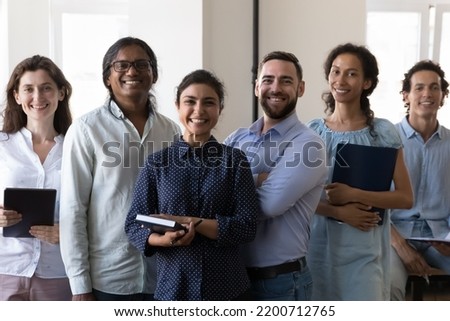 Diverse successful team of happy confident office workers of different races looking, smiling, posing at camera. Group portrait of Indian female leader, teacher with multiethnic employees Royalty-Free Stock Photo #2200712765