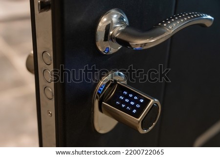 Open door to the apartment with a combination lock. Keyless entry. Royalty-Free Stock Photo #2200722065