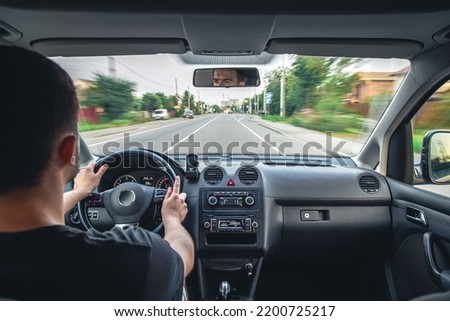 Hands on the wheel when driving at high speed from inside the car. Royalty-Free Stock Photo #2200725217