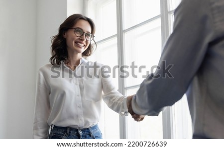 Young business people shaking hands in office. Handshake, finishing successful meeting. Business etiquette, congratulation, meeting, job interview, new business, startup, employee, teamwork, trust Royalty-Free Stock Photo #2200726639