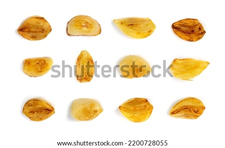 Fried garlic cloves set isolated with clipping path. Roasted grilled garlic clove collection on white background top view Royalty-Free Stock Photo #2200728055