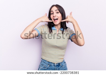 Young caucasian woman isolated on pink background showing a mobile phone call gesture with fingers.