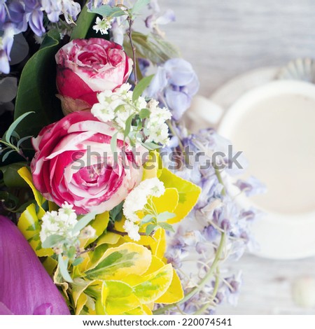 Spring flowers with cup of tea