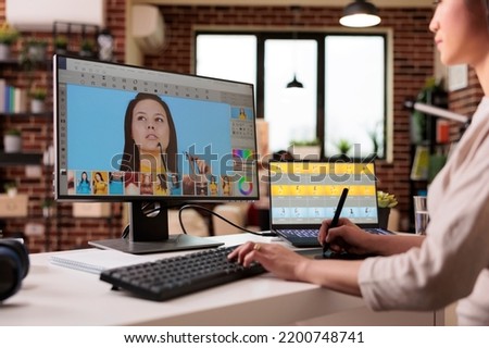 Asian photographer editing picture with retouching software on computer. Working with retoucher interface to edit art photograph with color grading and visual contrast, multimedia production.
