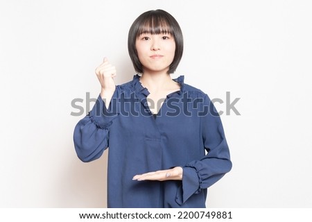 A young woman making a convincing pose in front of a white background