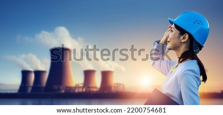 Female engineer looking at the nuclear power plant Royalty-Free Stock Photo #2200754681